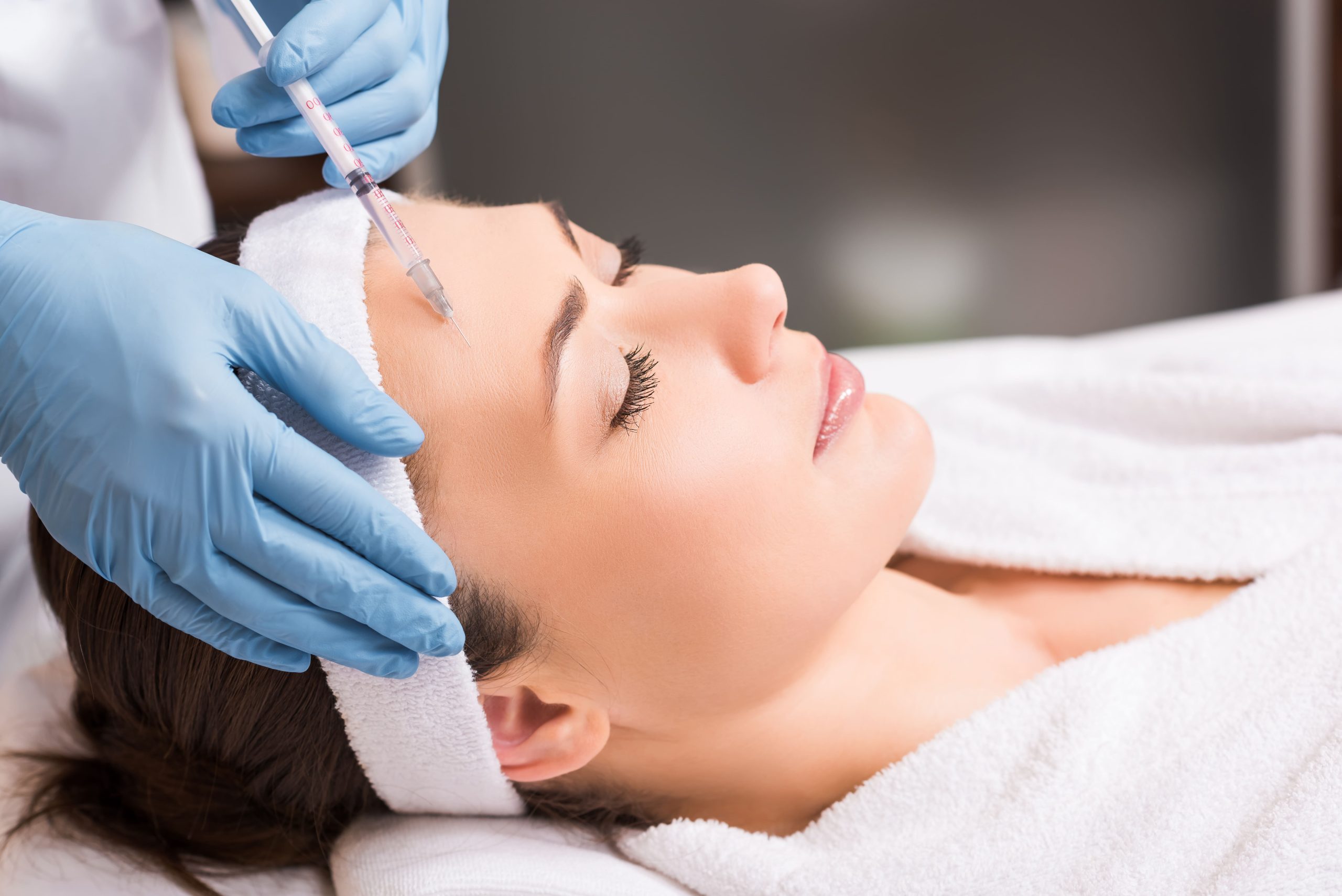 beautician-making-injection-to-woman-on-face-at-be-2023-11-27-04-49-53-utc