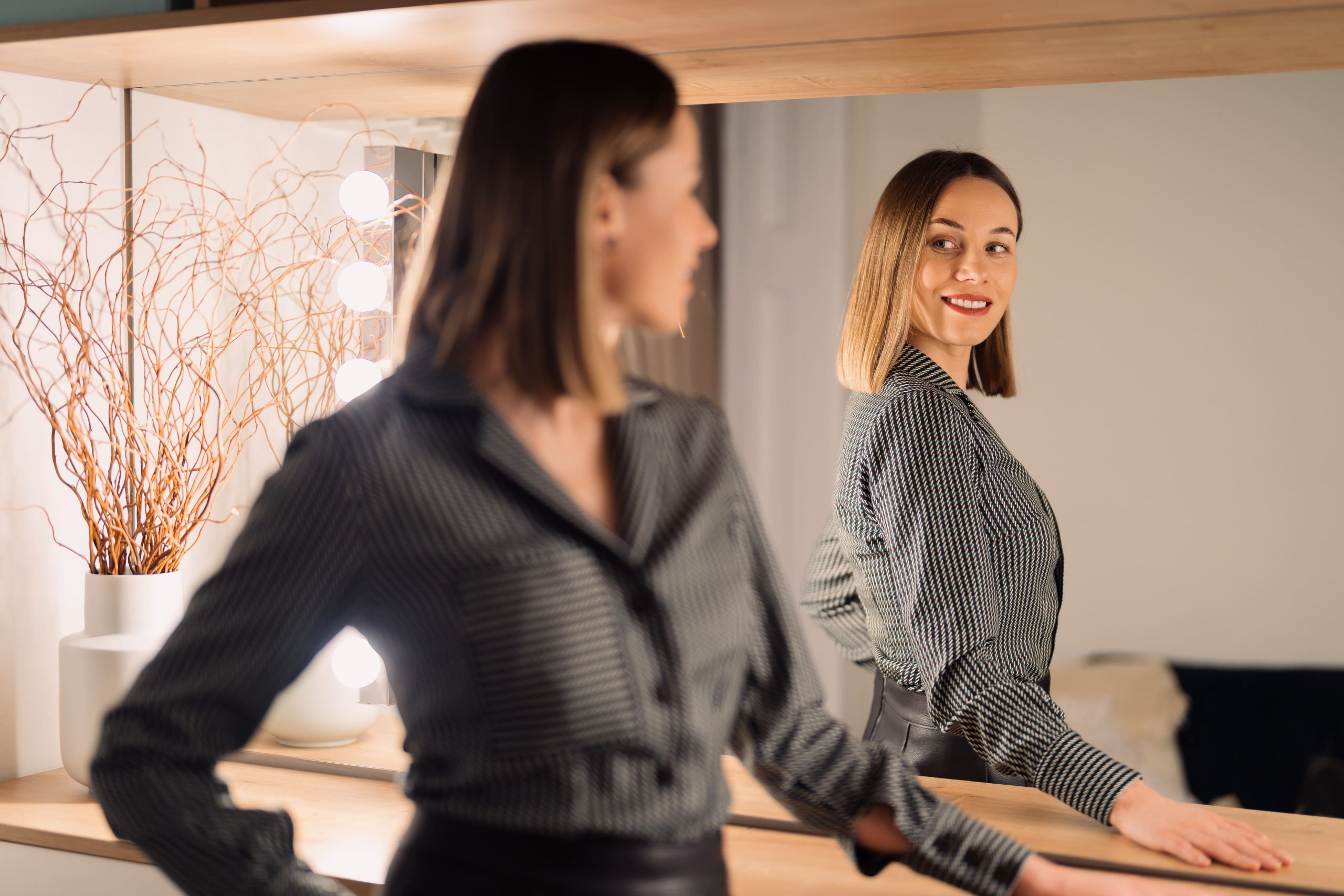 confident-woman-looking-to-her-reflection-into-the-2023-11-27-04-55-57-utc